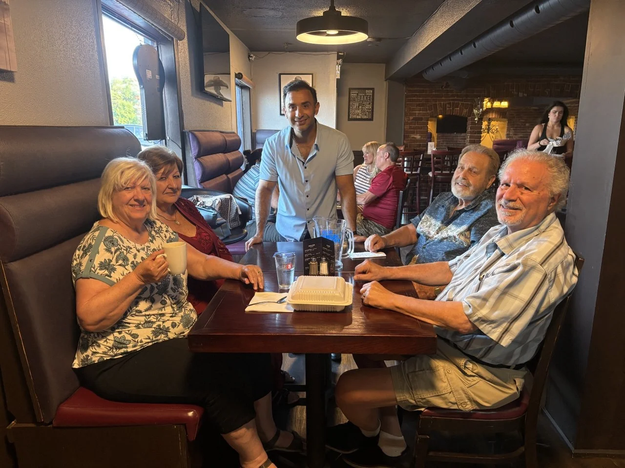 Friends gathered around a table at Friendly Fork